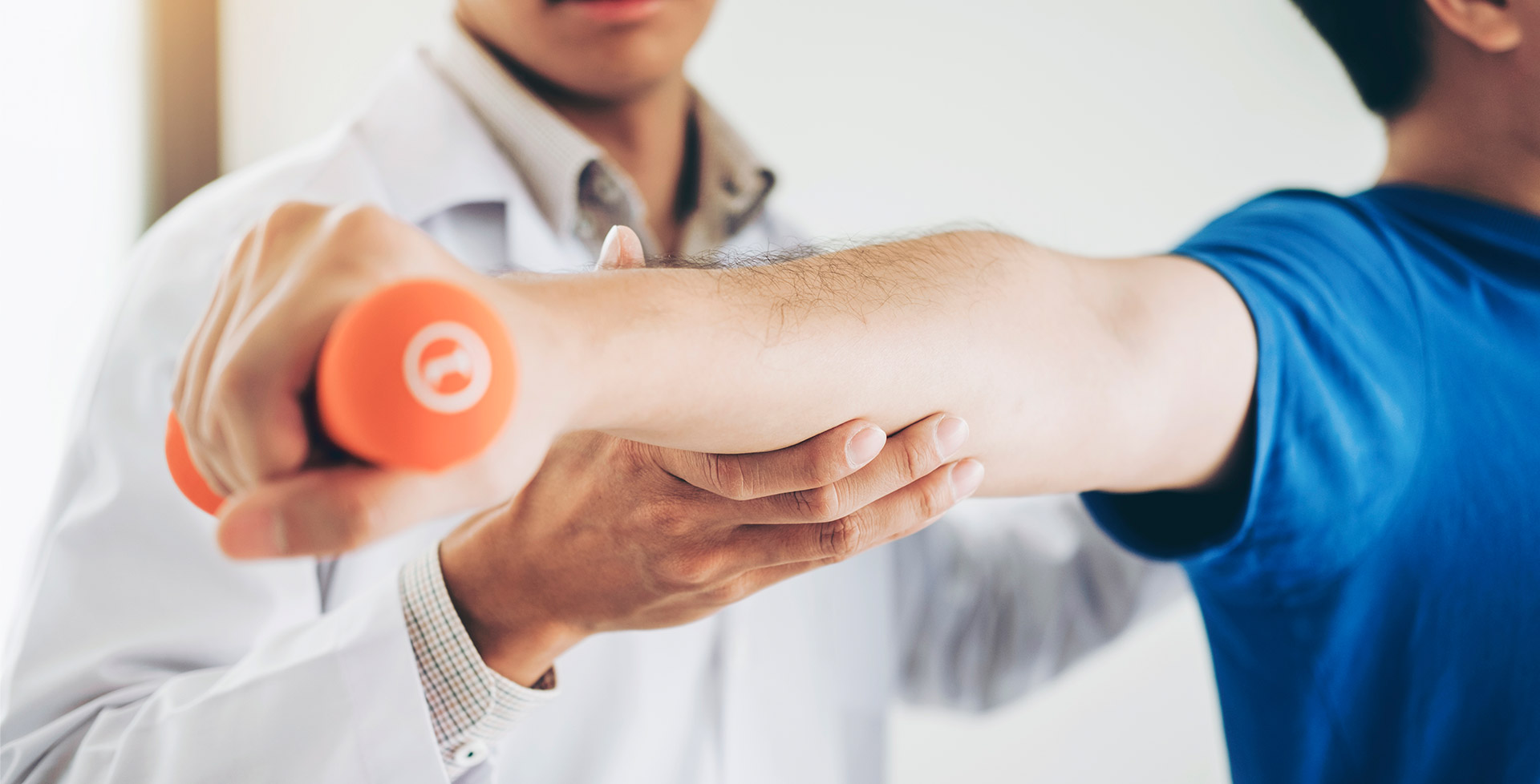 A man is holding his arm up to the side of another man 's arm.