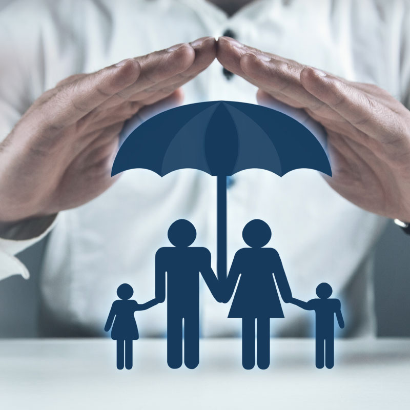 A person is holding an umbrella over their family.