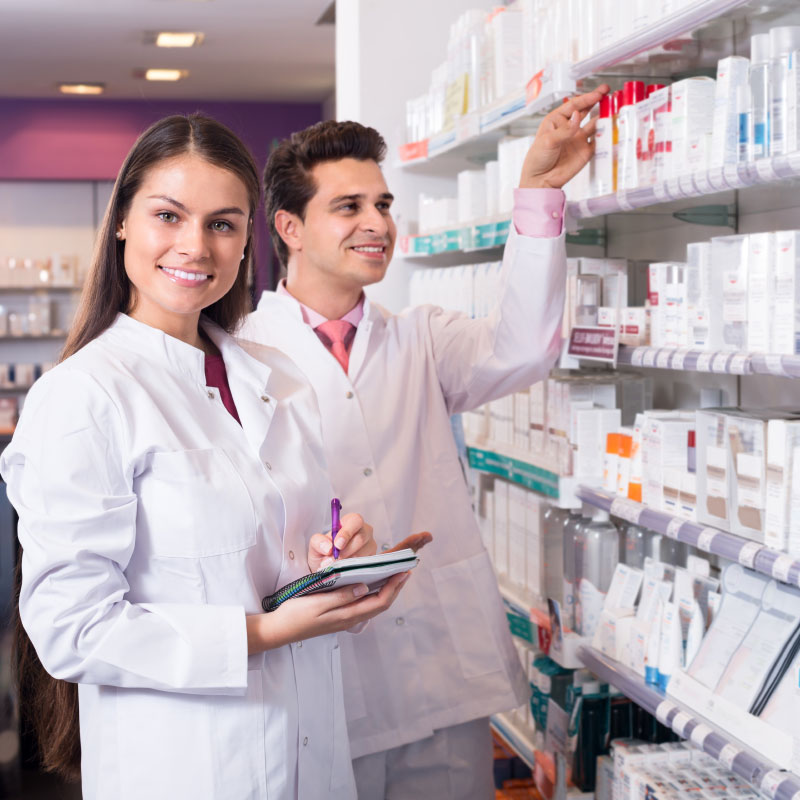 Two pharmacists are standing in a pharmacy.