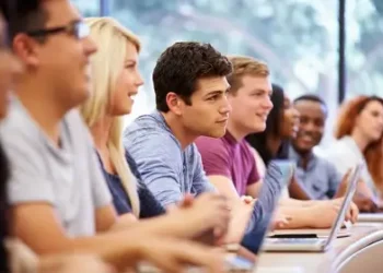 A focused shot on a man sitting in a row full of men and men